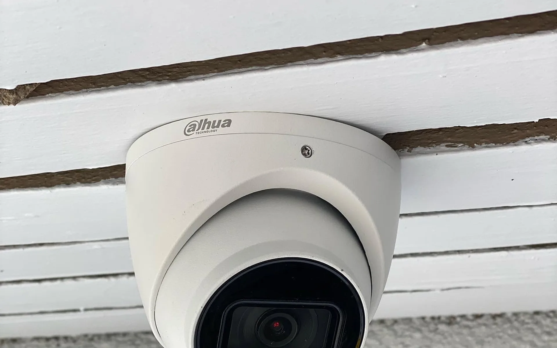 Security camera installed under the eaves of a house