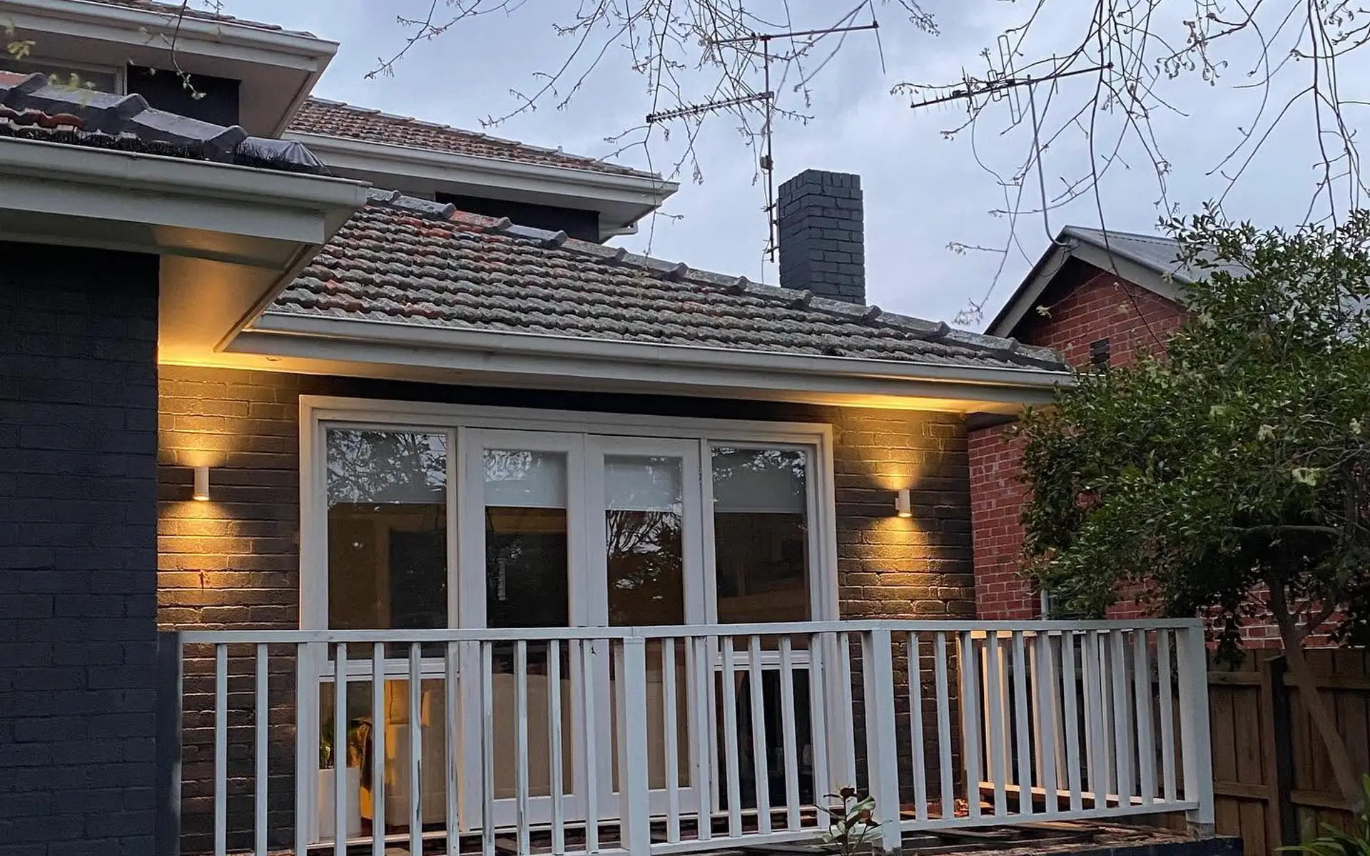 Exterior wall lighting installed at a home at dusk