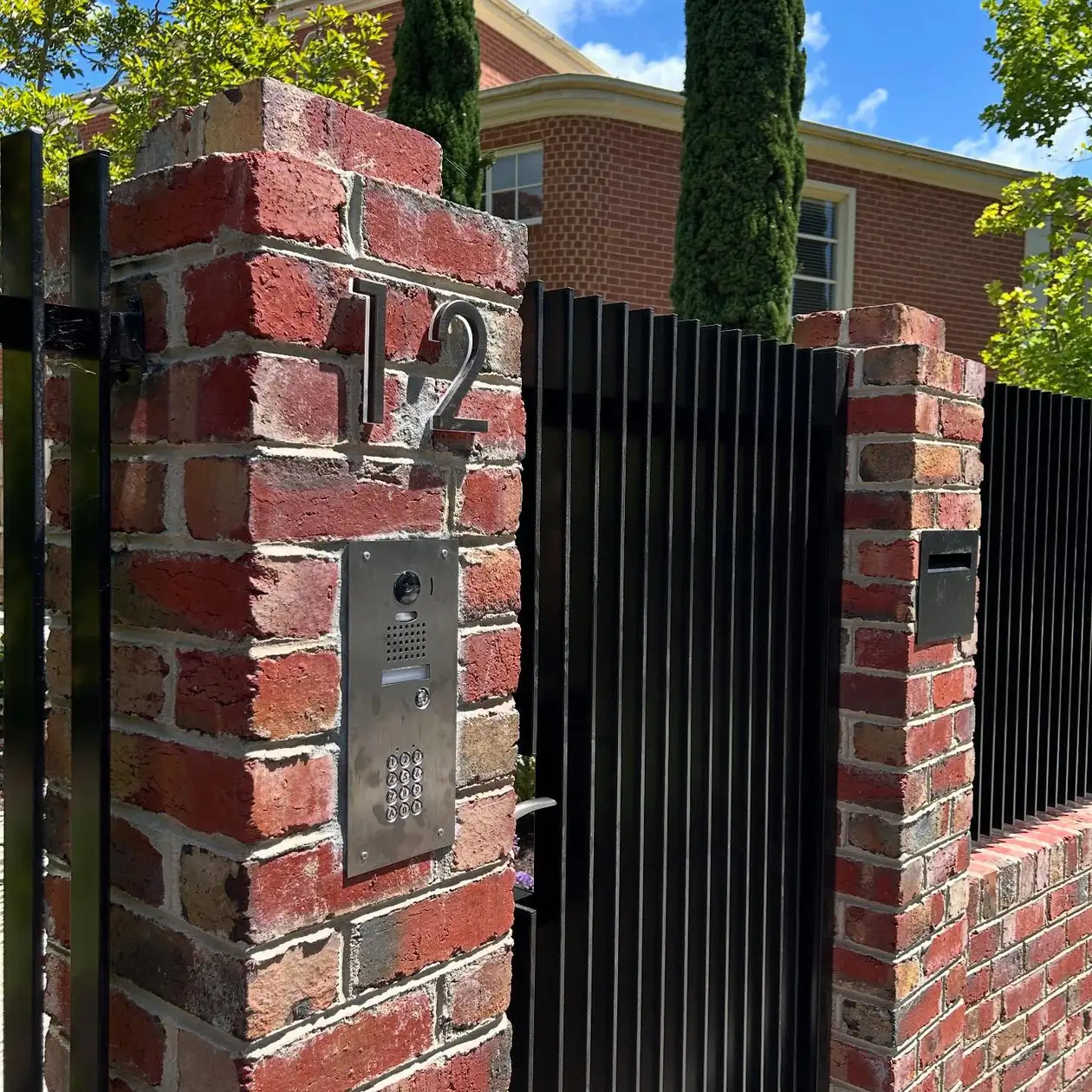 Intercom installed at a brick entry gate