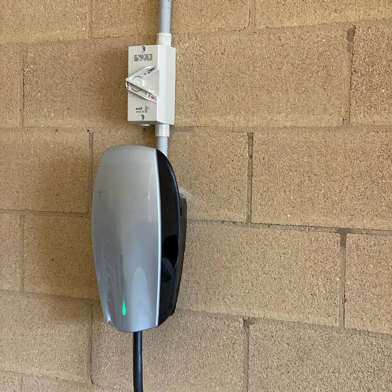 Wall mounted EV charger in a garage