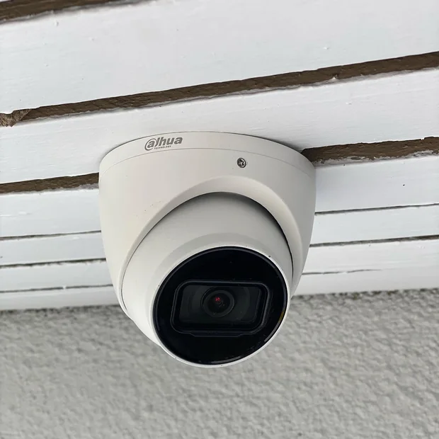 Security camera installed under the eaves of a house