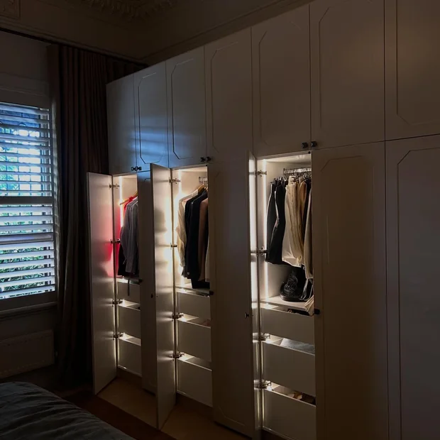 Lit shelving inside a walk-in wardrobe