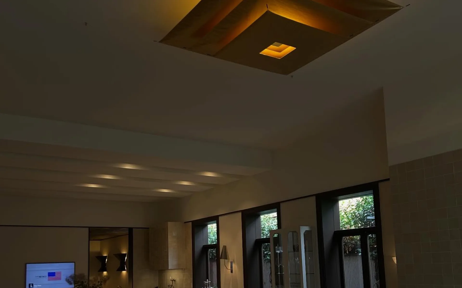 Dining area lit by a large feature ceiling light