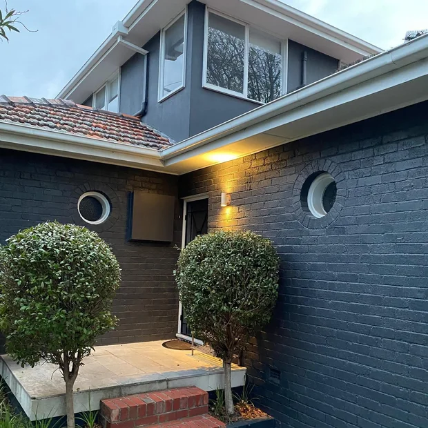 Wall lights beside an entry path