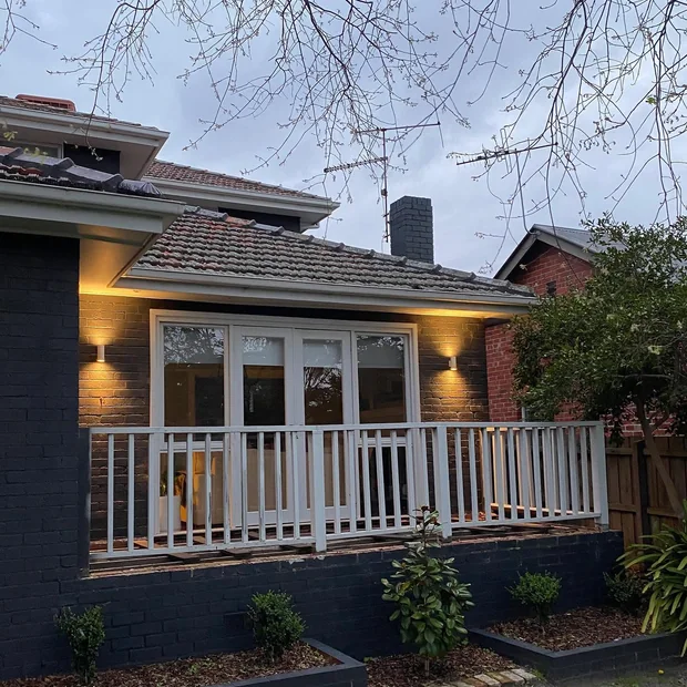 Wall lights on the front of a home at dusk