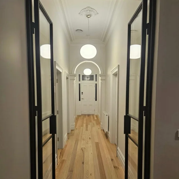 Hallway with pendant lighting after renovation